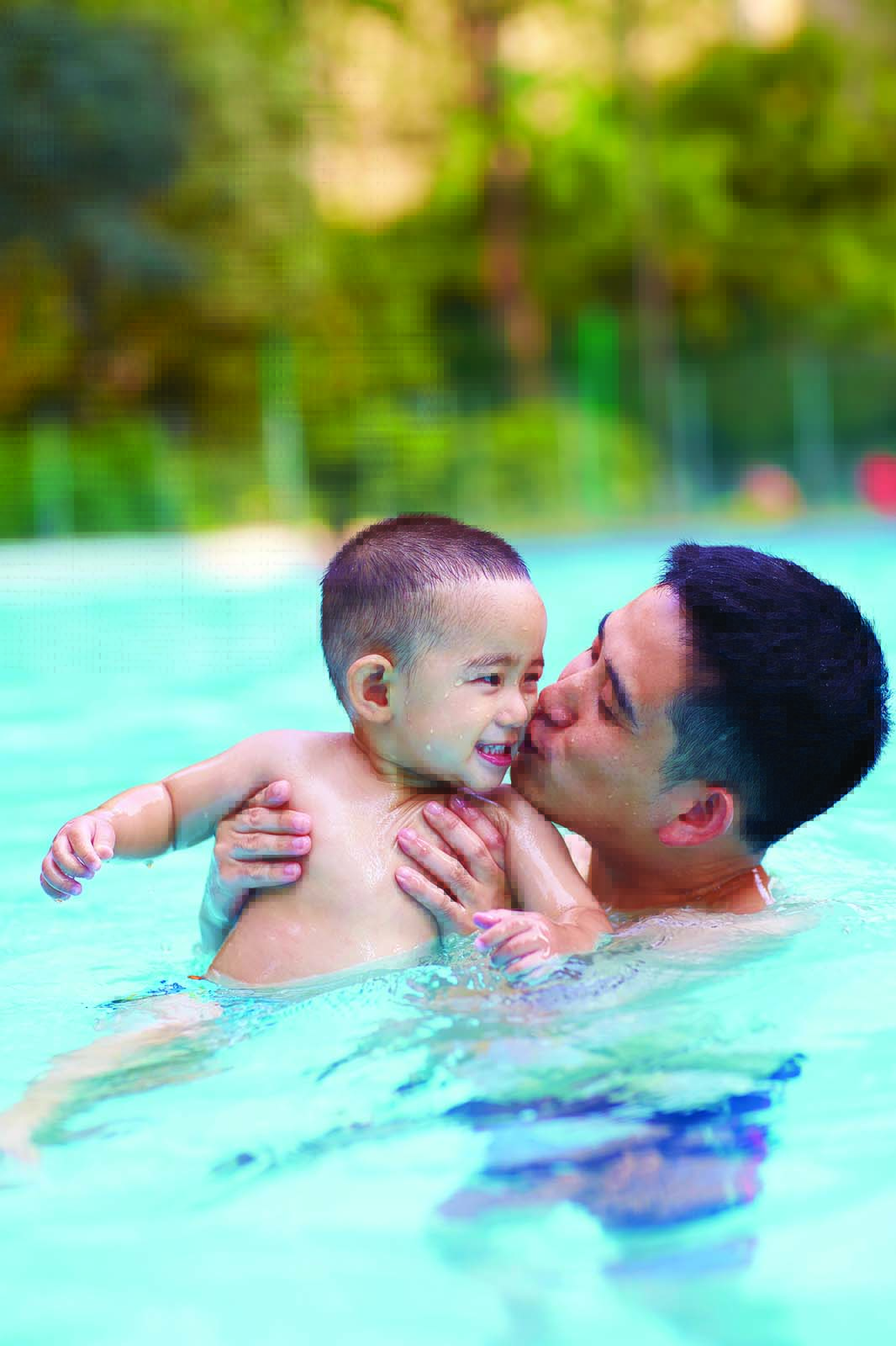 Father and baby in pool
