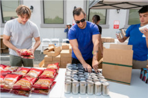 two men working on food donations