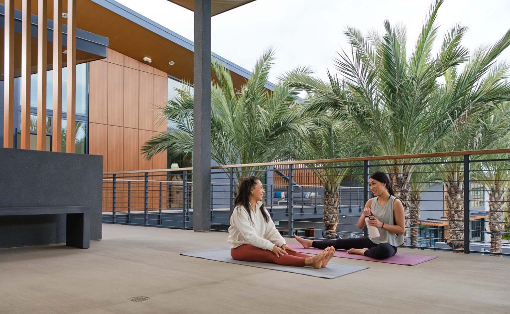 two woman practicing yoga at the rec center